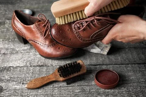 Worker cleaning shoe with brush Stock Photos