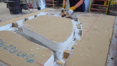 Worker cleaning slag from Kirksite mold in a foundry for car prototyping Stock Footage 334647296