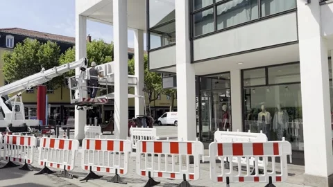 Worker Cleaning Store Facade from Aerial Work Platform in Lörrach Stock Footage 344085941