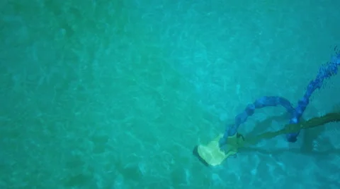 Worker cleaning swimming pool with pump Stock Footage 52568105