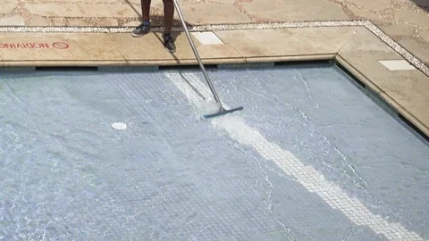 Worker is cleaning the water pool with brush Video stock 82240779