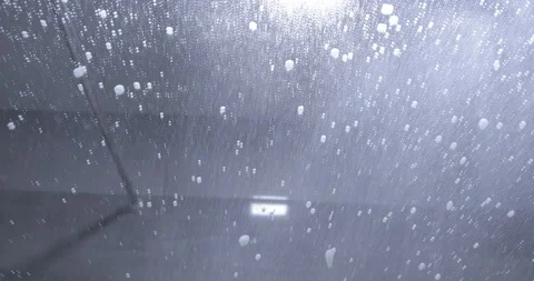 Worker cleaning the windshield. A man is washing a car 스톡 동영상 130996501