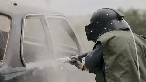 The worker cleans the cars elements by sanding. Sandblasting of metal Stock Footage 128263170