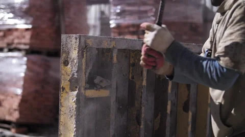 A worker cleans the formwork from concrete Stock Footage 255300137