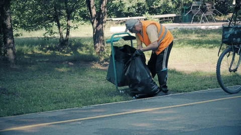 Worker cleans garbage in the city Park on a summer day Stock Footage 111817958