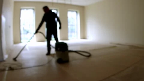Worker cleans the room with a hoover. Stock Footage 245427246