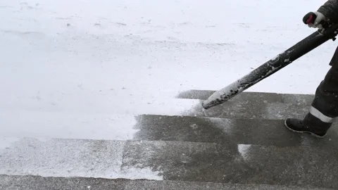 Worker cleans the sidewalk from snow Vidéo 224715871