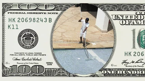Worker cleans the water pool in 100 dollar bill Stock Footage 96394684
