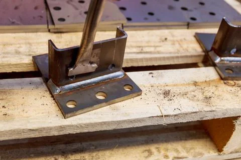 The worker cleans the welding seam with the help of a special home-made tool. Stock Photos