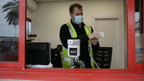 The worker cleans up the workplace.  The guard is doing disinfection.  soft focu Stock Footage 147056866