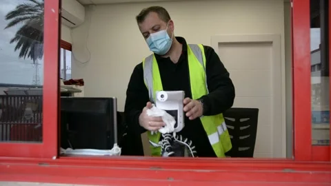 The worker cleans up the workplace.  The guard is doing disinfection.  soft focu Stock Footage 147057050