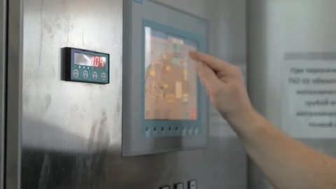 Worker clicks on touch screen of control panel on industrial equipment of Stock Footage 109917874