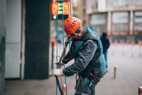 Worker climber preparing for work at height. Stock Photos