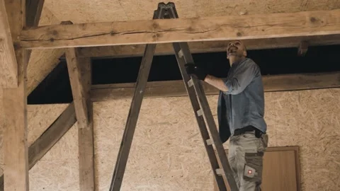 Worker climbing a ladder and measuring Stock Footage 149292760