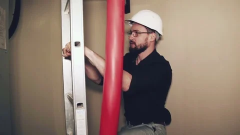 Worker climbs up metal ladder Stock Footage 73469346