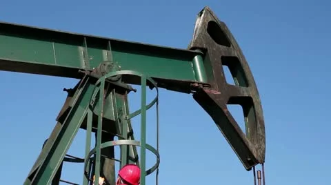 Worker Climbs Up on the Pump Jack Stock Footage 12467303