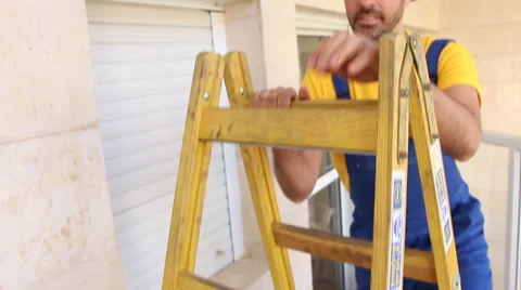 Worker climing a ladder Stock Footage 33662192