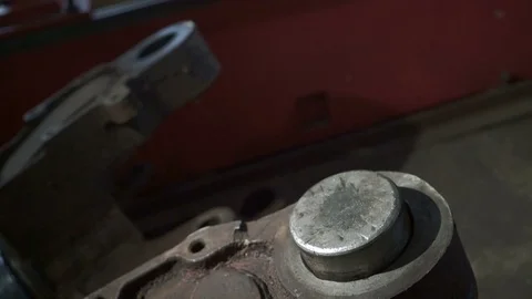 Worker clogs the bushing. Sledgehammer. Heavy machine workshop Stock Footage 75340779