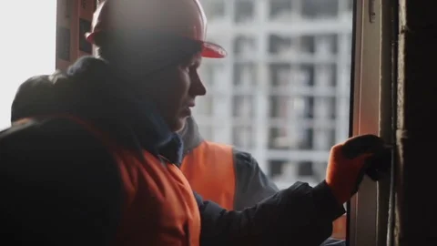 Worker clogs the screw into the wall Stock Footage 82296040