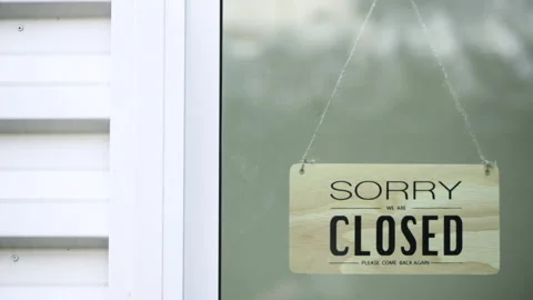 Worker is closed the window and turning a sign from closed to open sign Stock Footage 207479017