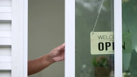 Worker is closed the window and turning a sign from open to closed Stock Footage 207480713
