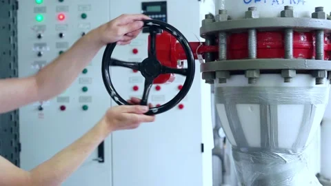 Worker closes the valve liquid to the heating system of the gas boiler room. Stock Footage 203901261