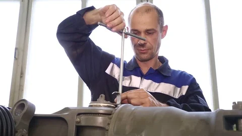 The worker collects the engine. Stock Footage 86193368
