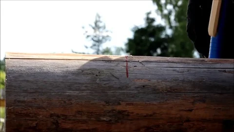The worker collects the frame and drills a hole in a log for dowel using a drill Stock Footage 77427301
