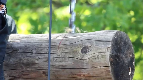 The worker collects the frame and drills a hole in a log for dowel using a drill Stock Footage 77427321