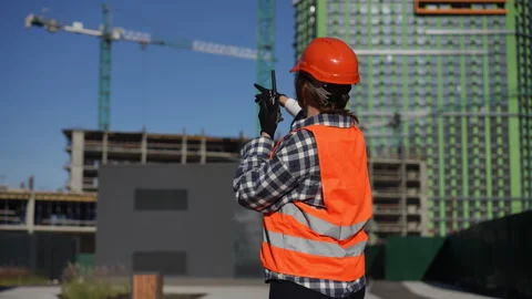Worker is communicating effectively at a busy job site with tools and equipment Stock Footage 311859841
