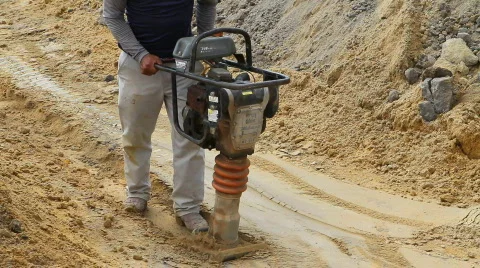 Worker Compacting Soil Stock Footage 879169