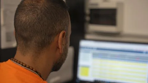 Worker at computer managing customer orders and logistics in modern office .. 写真素材