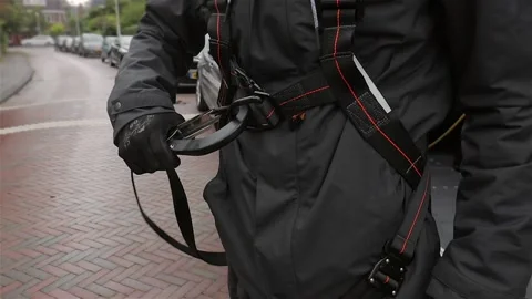 Worker connecting his safety hook on a fall protection harness Stock Footage