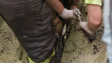 The worker is connecting two power transmission line cables and tightening the Stock Footage 244642167