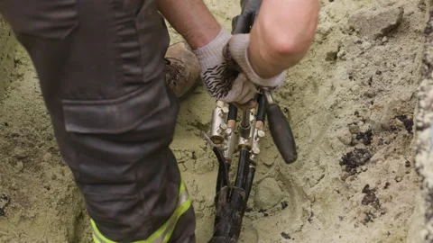The worker is connecting two power transmission line cables and tightening the Stock Footage 244642552