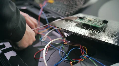 A worker connects the chips of a traffic light at a production site. Close-up Stock Footage 137578517