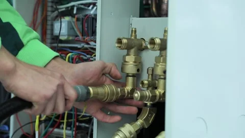 Worker connects hoses to air conditioning cooling system Stock-Footage 162904204