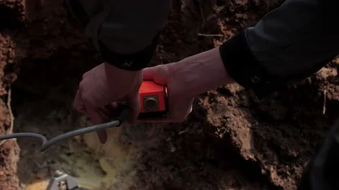 Worker connects meter to exact seismographical sensor Stock Footage 136052769