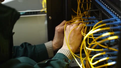 Worker connects optical line internet wire in connection box. Service man Stock Footage 156341624