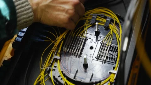 Worker connects optical line internet wire in connection box. Service man Stock Footage 156871137