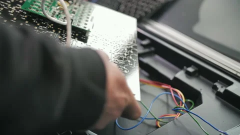 A worker connects a traffic light chip at a factory. LEDs, energy saving traffic Stock Footage 137575501