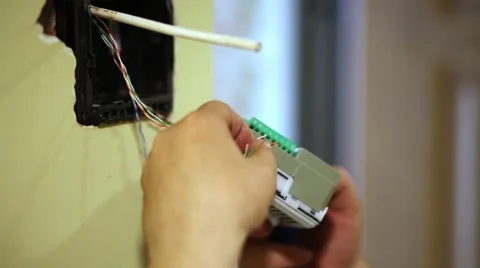 Worker connects wires to external block of home intercom. Stock Footage 51876360
