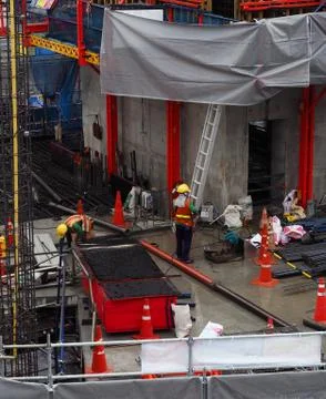 Worker in construction area work in wet place after heavy rain Foto stock