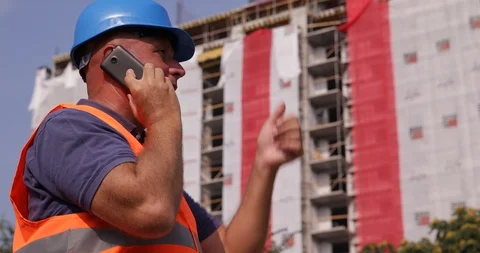 Worker From a Construction Company Talking to Cell Phone and Gesticulate Stock Footage 102257515
