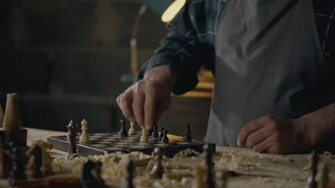 Worker, Construction engineer Holds a chess piece in his hands looks at the Stock Footage 245437051