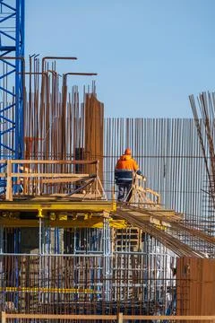 Worker on construction site on cloudless day Stock Photos