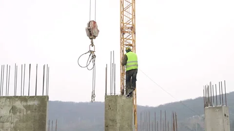 The worker on the construction site, is on the construction of concrete, and Stock Footage 102598374