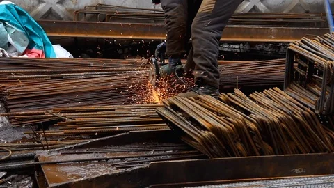 Worker at a construction site cuts metal by electric saw. Stock Footage 126293455