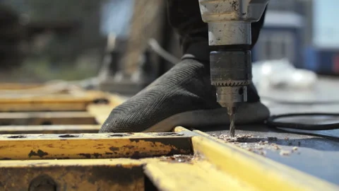 A worker at a construction site drills a hole Stock Footage 282240609