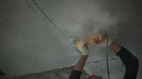 Worker at a construction site grinds a concrete wall Stock Footage 288007854